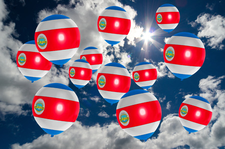 many ballons in colors of costa rica flag flying on skyの写真素材