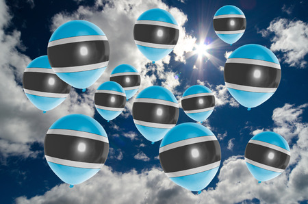 many ballons in colors of botswana flag flying on skyの写真素材