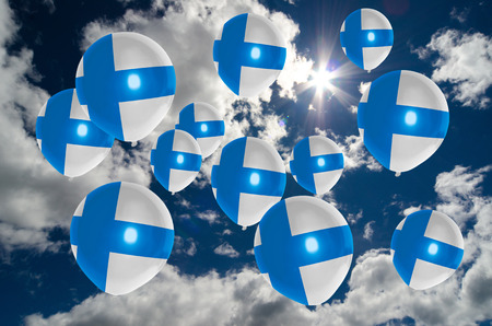 many ballons in colors of finland flag flying on skyの写真素材