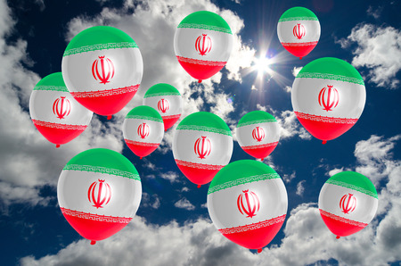 many ballons in colors of iran flag flying on skyの写真素材