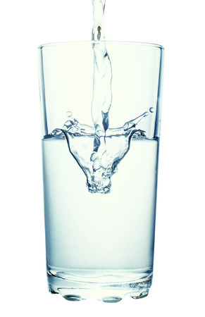 water pouring into glass isolated on white backgroundの写真素材