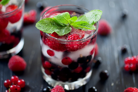fruit coctail and color berries on natural dark wooden deskの写真素材
