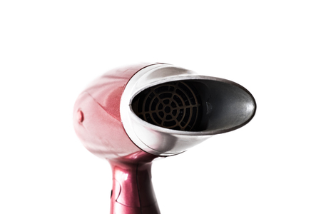 Red hair dryer for drying hair on a white backgroundの写真素材