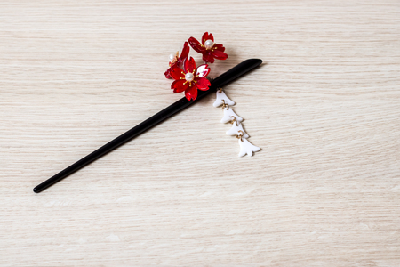 Japanese kanzashi hair accessory on a wooden table, beauty traditionsの写真素材