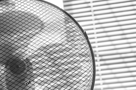 White fan on the window background close up, black and white, summer heatの写真素材