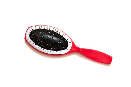 Red hairbrush on a white background, isolated, hair care and beautyの写真素材