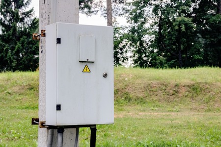 Box with electricity on a concrete column with the sign dangerの写真素材