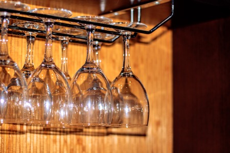 Empty glasses, glasses and glasses on a tray on the background of bottles