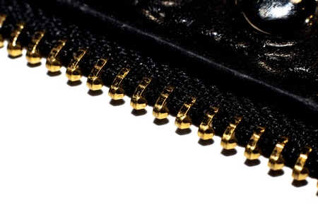 Metal yellow zipper close up on a white background