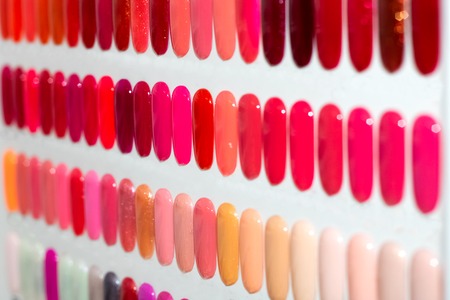 Nail polish on the artificial plastic nails, fashion and beauty