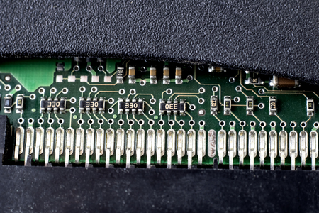 Green PCB in black plastic case close up