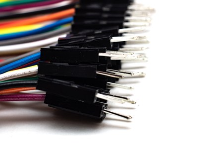 Thin multicolored wires with connectors, arduino wire on white background