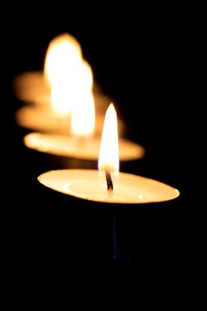 Candle flame on the background of other candlesm close up