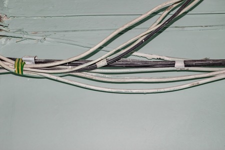Many old white wires on the wall, fire safety violation