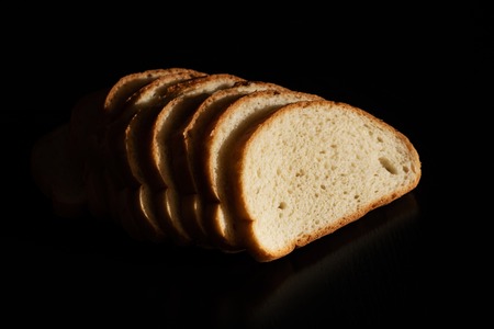 Slices of white bread on a dark background close upの写真素材