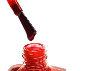 Brush and jar with red nail polish, isolated on white backgroundの写真素材