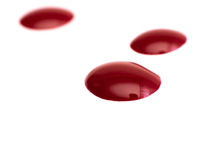 Three red drops close up, isolate on a white backgroundの写真素材