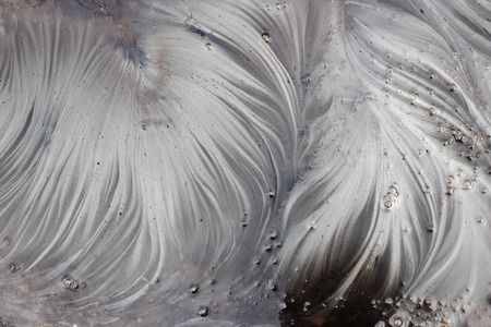 Gasoline stains in the form of feathers on the water, texture or backgroundの写真素材