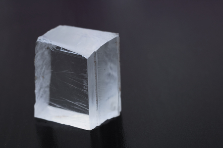 Lighted glass cube on dark background close up, copy spaceの写真素材