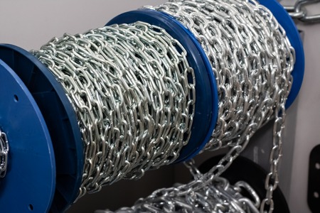 Large chain wound into a blue coil close up, copy spaceの写真素材