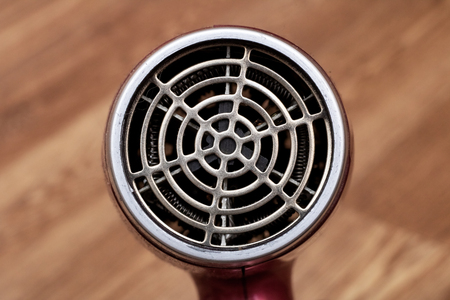 Fan blow dryer close up on a wooden backgroundの写真素材