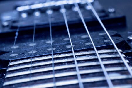 Strings on a black guitar close up, macro photoの写真素材