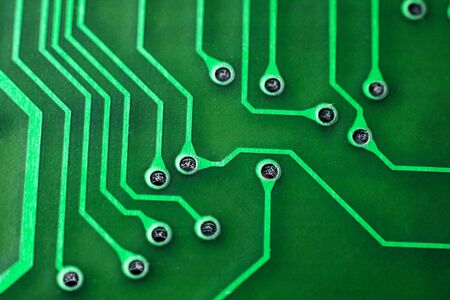 Tracks on a green printed board close up, macro photo