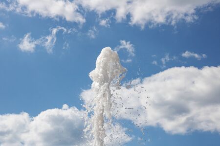 Spray of water from the fountain on the background of blue sky close upの写真素材