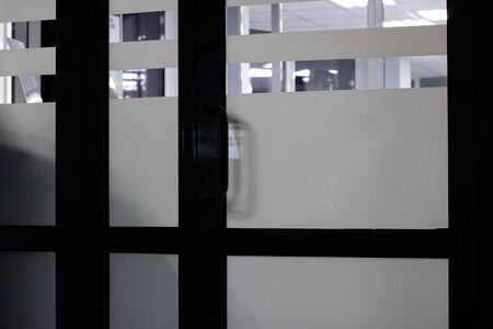 Glass door indoors in the dark close upの写真素材