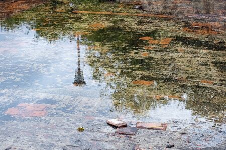 Background from a puddle on paving slabs close upの写真素材