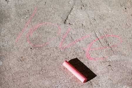 The word love written on the asphalt with chalkの写真素材