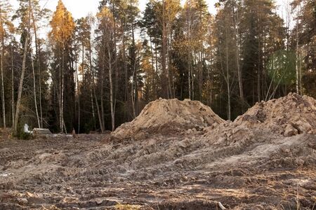 Piles of sand at a construction site in the forestの写真素材