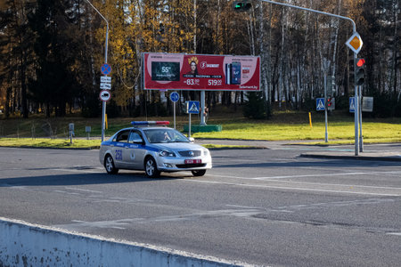 BELARUS, NOVOPOLOTSK - OKTOBER 16, 2019: Police car on a wide road and traffic lightのeditorial素材