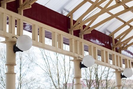 White lanterns in the shape of a ball on columnsの写真素材