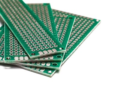 Green prototyping board in a pile isolated on a white background