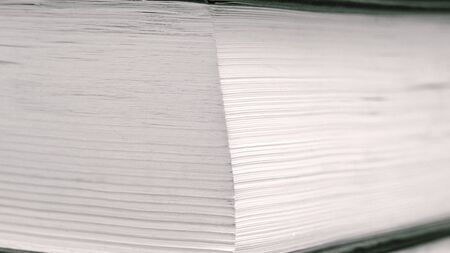 Corner of a book with white pages close up, background