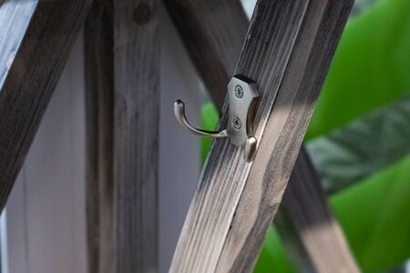 Clothes hook on a wooden wall close upの写真素材