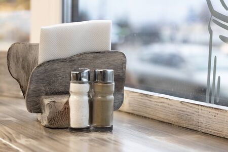 Wooden napkin holder, salt and pepper on a wooden table copy spaceの写真素材