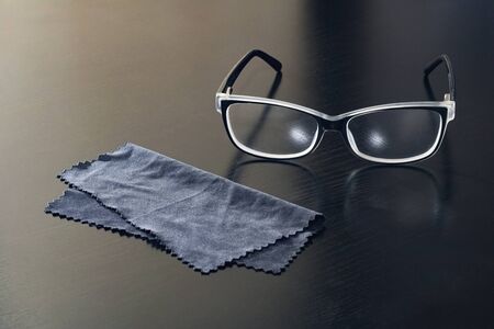 Glasses and a black napkin on a wooden table close upの写真素材
