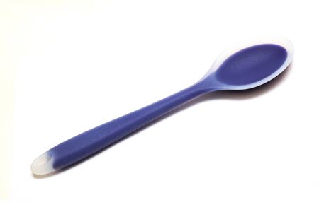 Blue silicone spoon close up isolated on white backgroundの写真素材