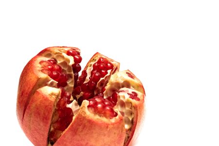 Sliced pomegranate with red grains, isolated on a white backgroundの写真素材