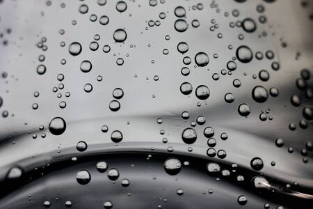 Bubbles in water on a gray background close upの写真素材