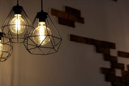 Retro style lamps on brick wall background, copy space