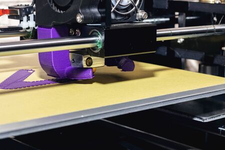 The process of printing from plastic to a 3D printer close up