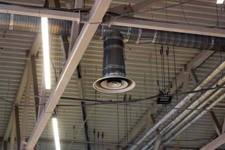 Electric industrial hood on a metal ceiling close up