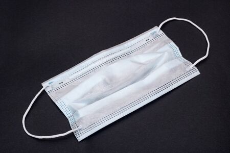 Medical face mask on a gray background close up