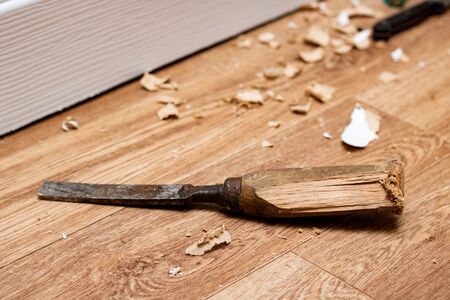 Chisel among sawdust on a wooden floor close upの写真素材