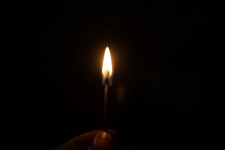 Burning match in the dark close up, macro photoの写真素材
