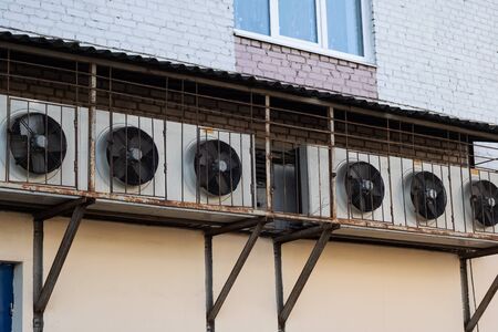 Conditioners in a row on the wall of the house close up