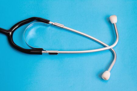 Part of a stethoscope on a blue background close upの写真素材
